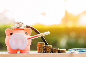 a piggy bank with a thermomenter in it's mouth - symbolic of how to calculate self=employed sick pay.